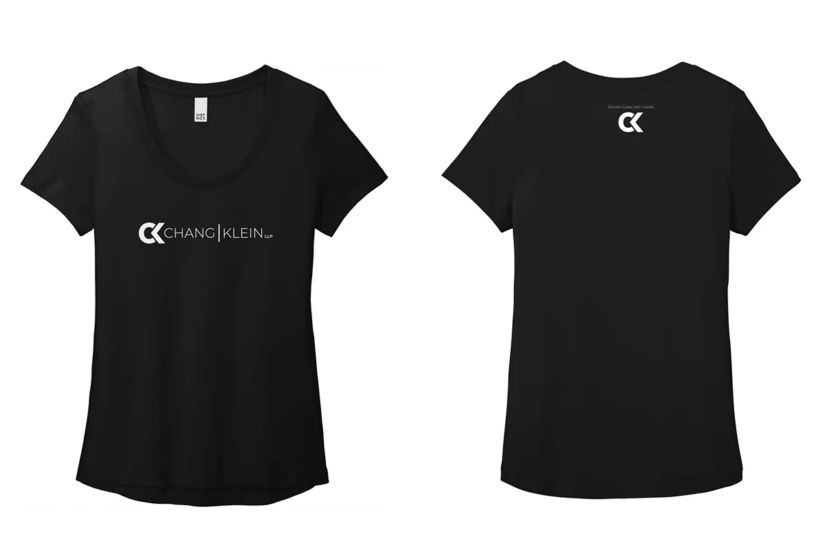 Black tee front with a Chang Klein wordmark and back with a small CK monogram and tagline at the neck.